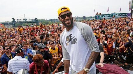 LeBron James, center, stands in the back of