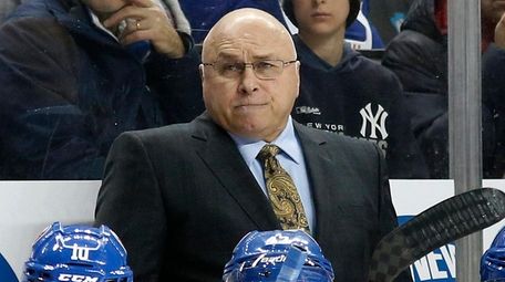 Islanders head coach Barry Trotz looks on in