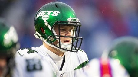 Sam Darnold of the Jets moves behind the