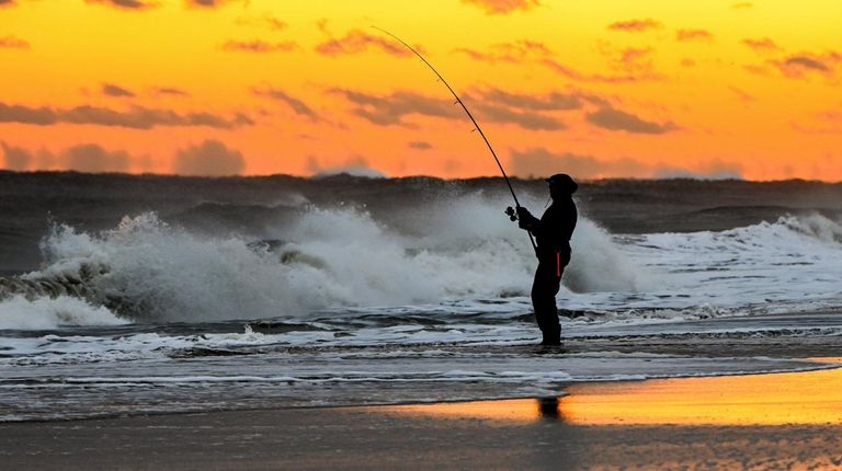 Fishing for stripped bass on the shore of