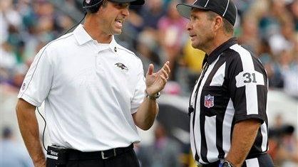 Baltimore Ravens head coach John Harbaugh talks to