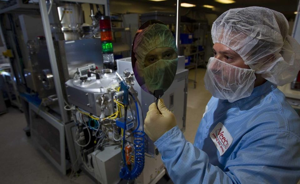 Veeco mechanical engineer Mathew Levy holds a data