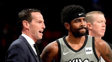 Nets head coach Kenny Atkinson speaks with Kyrie