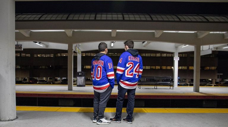 Teens wait on the platform at the Hicksville