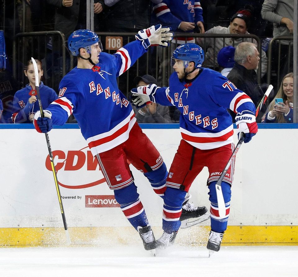 Chris Kreider, left, of the Rangers celebrates his