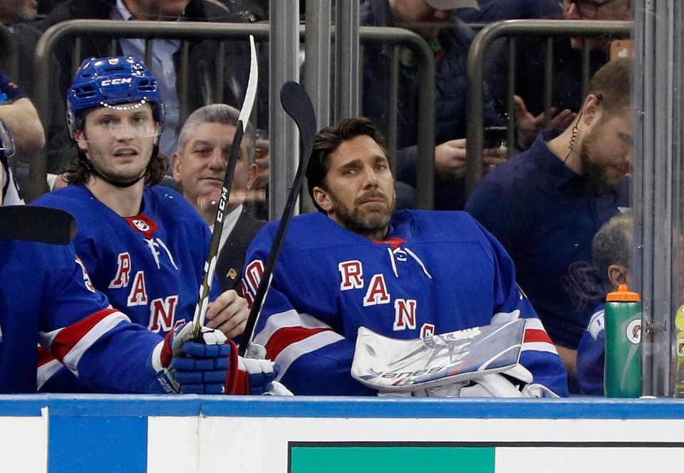 Henrik Lundqvist #30 and Jacob Trouba #8 of