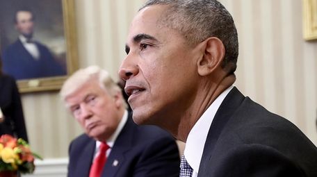 President-elect Donald Trump listens as President Barack