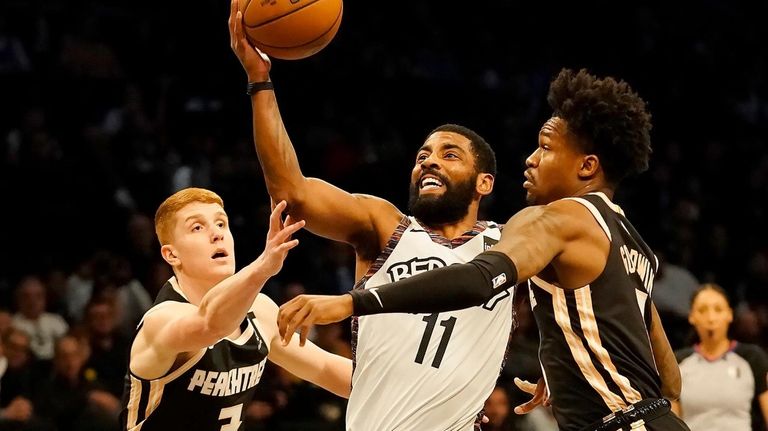 Brooklyn Nets guard Kyrie Irving drives between Atlanta