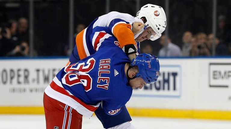 Ross Johnston of the Islanders fights Micheal Haley