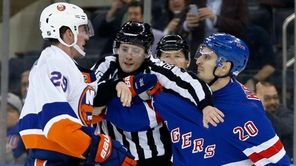 Linesman Libor Suchanek tries to separate Brock Nelson