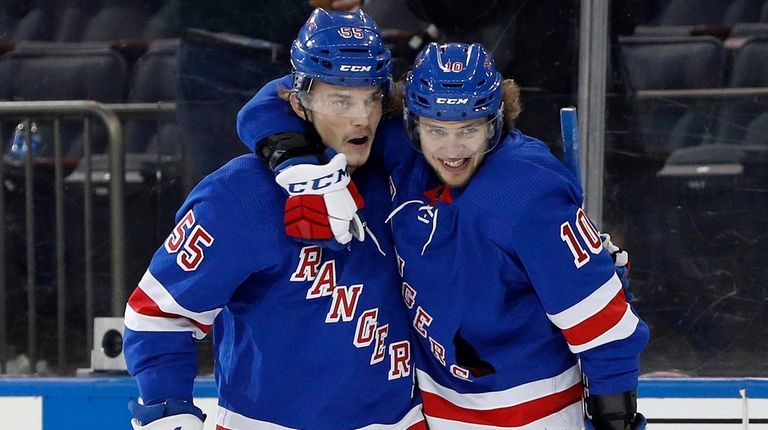 Artemi Panarin of the Rangers, right, celebrates his