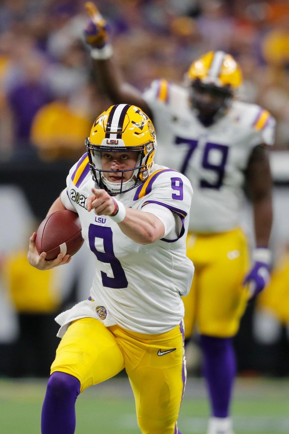 LSU quarterback Joe Burrow runs against Clemson during