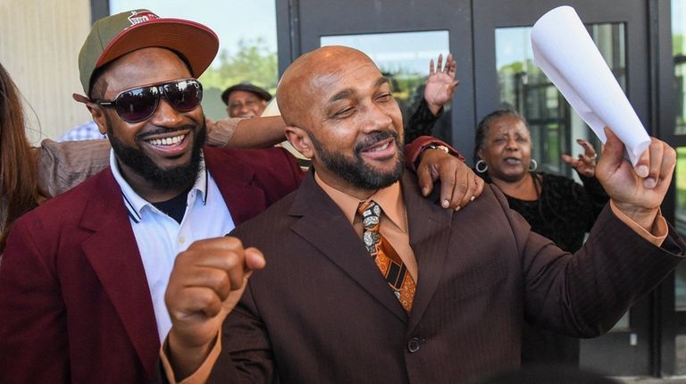 Keith Bush, right, leaves Suffolk County Court in