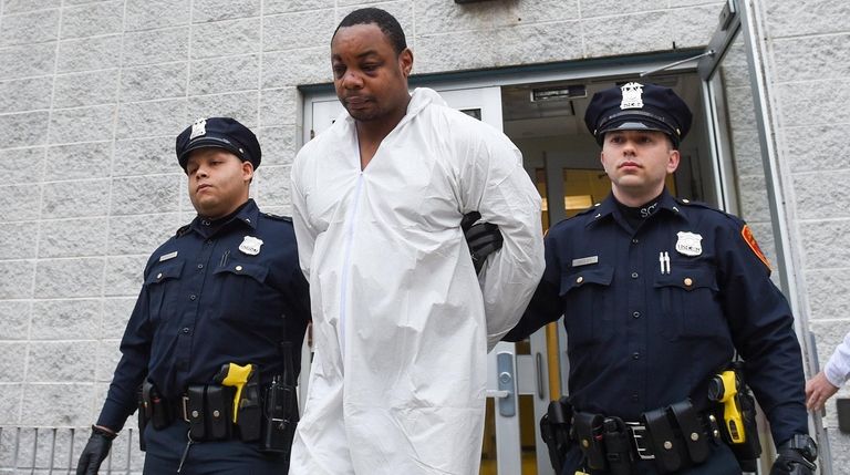 Jordan Randolph, 40, of Bellport, is led out