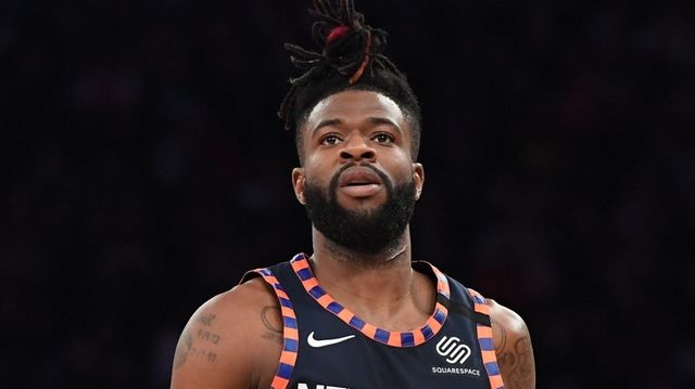Knicks guard Reggie Bullock looks on against the