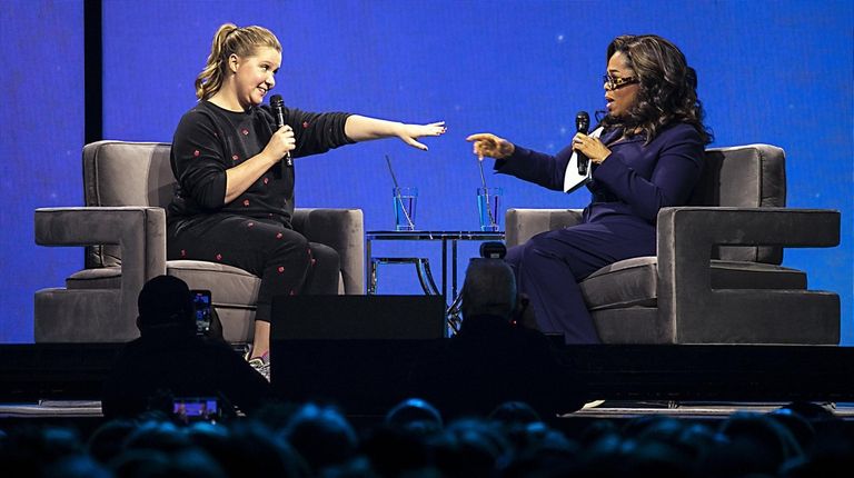 Amy Schumer and Oprah Winfrey speak during the