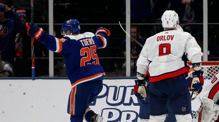 Devon Toews of the Islanders celebrates his second-period