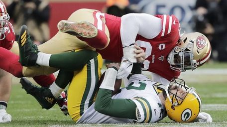 Green Bay quarterback Aaron Rodgers is sacked by