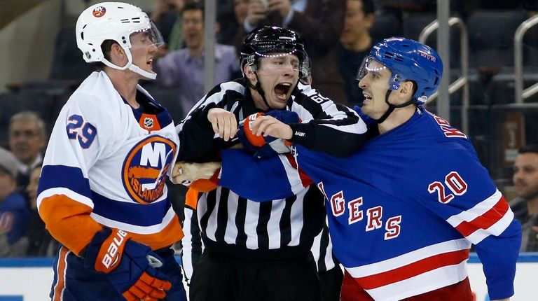 Linesman Libor Suchanek tries to separate Brock Nelson