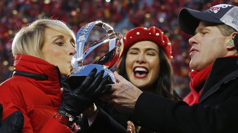 Kansas City Chiefs owner Clark Hunt, right, holds