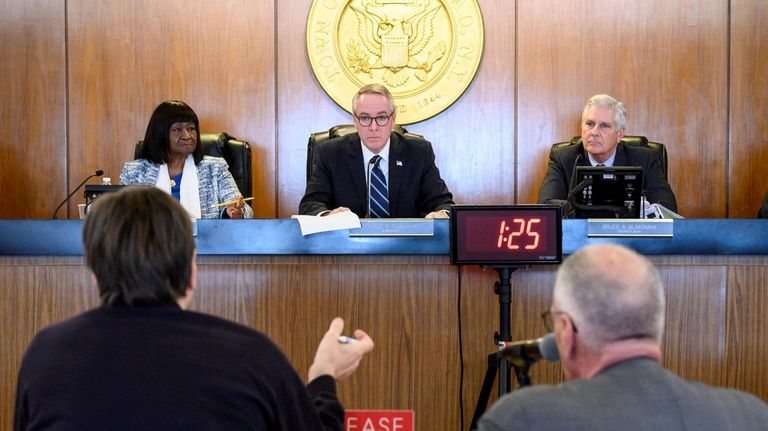 Hempstead Supervisor Don Clavin, center, is flanked by