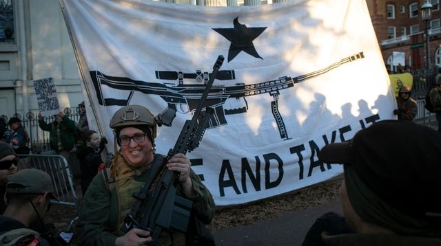 Brandon Lewis, of Bergen, New York, carries a