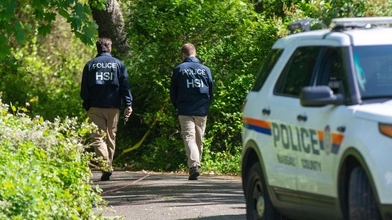 Nassau police with federal partners conduct an investigation