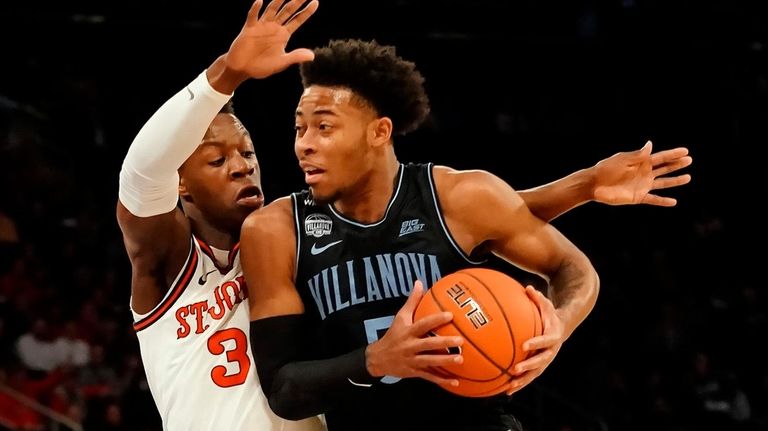 Villanova Wildcats guard Justin Moore drives into the