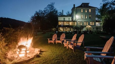 Adirondack chairs and a cozy fire await guests