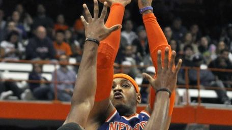New York Knicks' Carmelo Anthony, right, shoots over