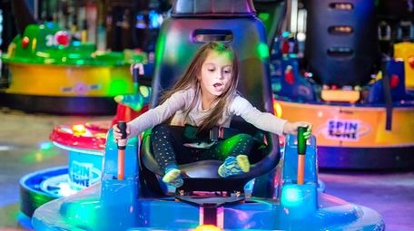 Milania Triolo, 7, of Holbrook, plays at Urban