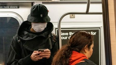 A subway rider wears a mask on Tuesday.