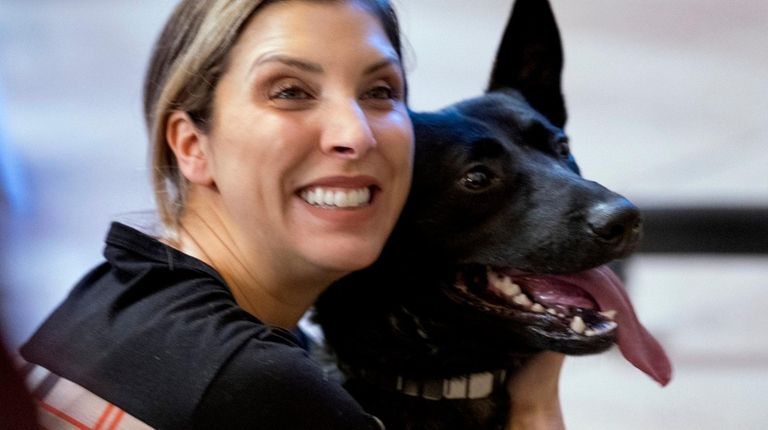 Carmela Raguso of Commack hugs MTA police dog