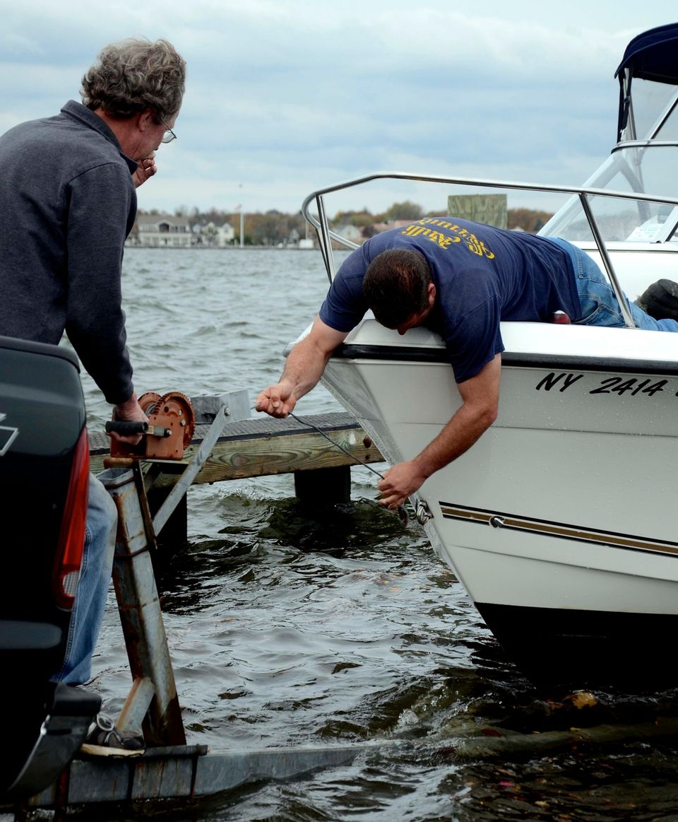 At left, John Basler, 57, of Babylon, cranks