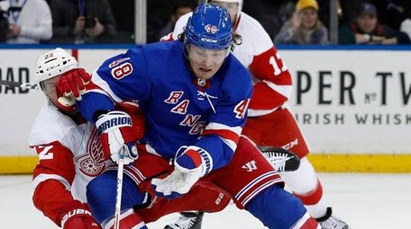 Brendan Lemieux of the Rangers plays the puck