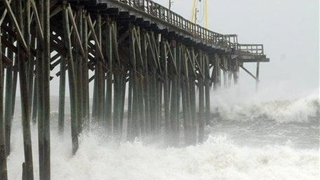 Waves pound Carolina Beach pier in Carolina Beach,