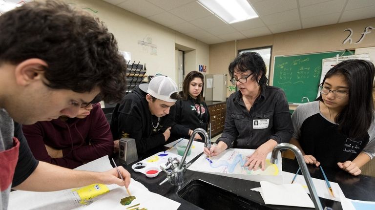 Artist Susan Buroker, second from right, works with