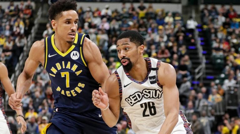 Spender Dinwiddie drives against Pacers' Malcolm Brogdon in