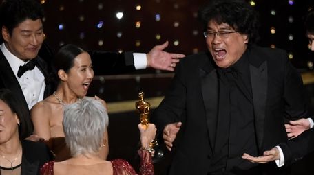 Bong Joon Ho, right, reacts as he is