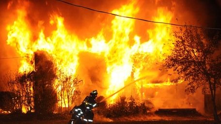 Firefighters battled a blaze at a large two-story