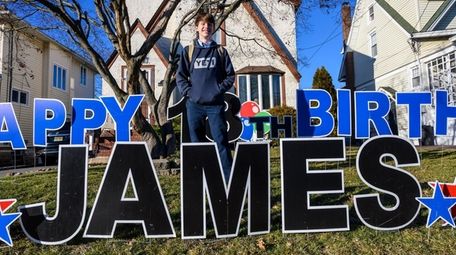 James Culhane poses with a giant "Happy 18th