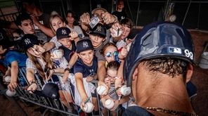 New York Yankees' OF Aaron Judge signing autographs