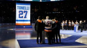 Former Islander John Tonelli stands with his family