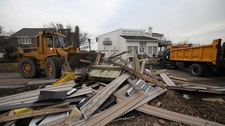 Village of Lindenhurst workers use heavy machinery to