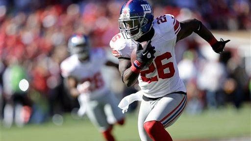 Antrel Rolle runs with the ball during a