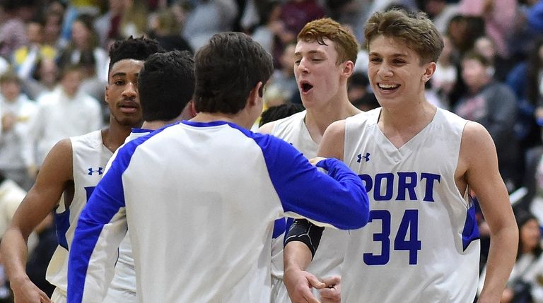 Dylan Trenaman of Port Washington, right, and teammates