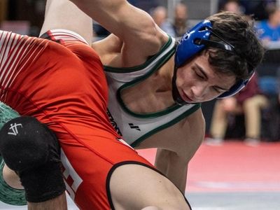 Long Beach's Jeremiah Echeverria, in green, facing off