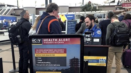 Travelers at a TSA security checkpoint at Denver