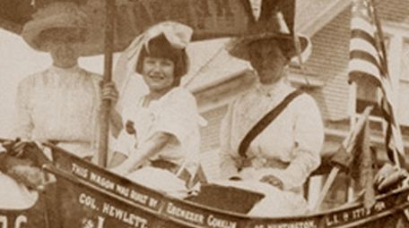 Sitting in the Suffragist wagon, from left, are