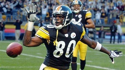 Plaxico Burress celebrates a touchdown during a game
